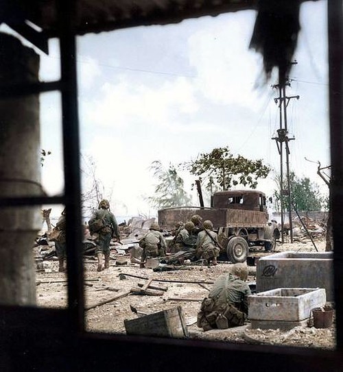 US Marines firing at Japanese soldiers hiding behind debris